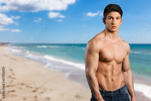 Portrait of handsome young sporty man on the beach © BillionPhotos.com