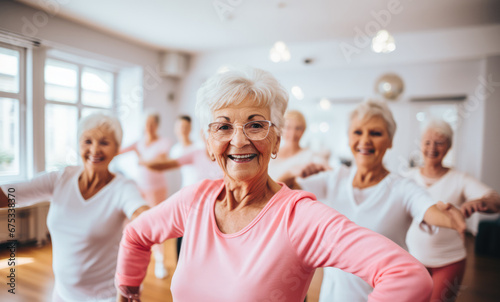 Group of elderly women friends doing a workout or training class together. Gym, fitness, sport, pilates, yoga concept.