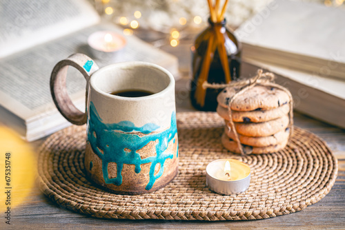 Cozy autumn composition with a handmade cup close-up.