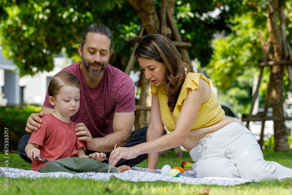 Fototapeta premium Happy family day, father, mother, son, Caucasian enjoying watercolor painting and picnic in nature.