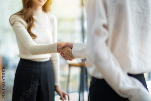 Close up of businesswoman shaking hands during a meeting success, dealing, greeting and partner concept.