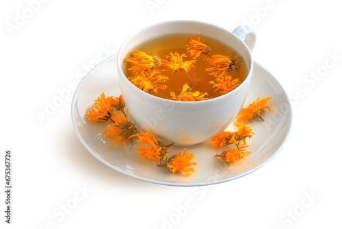 Cup and saucer with calendula tea isolated on white background