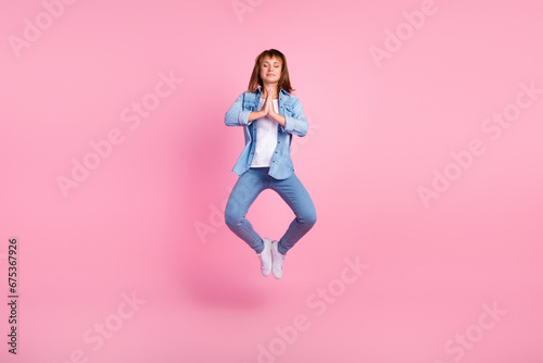 Full body photo of young girl jumping dressed stylish outfit isolated on pink color background