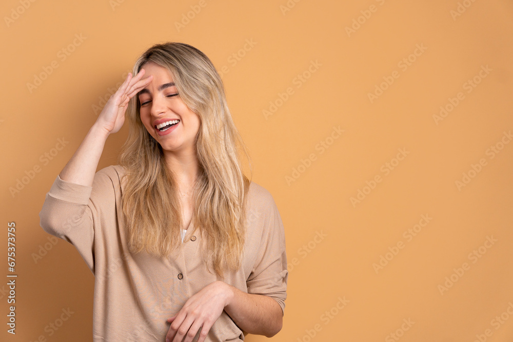 fun caucasian woman laughing happily in beige colors. joy, people concept. fun caucasian woman laughing happily in beige colors. joy, people concept.