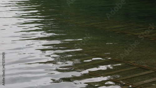 Water ripples over submerged boat loading tracks at Lake Shikaribetsu photo