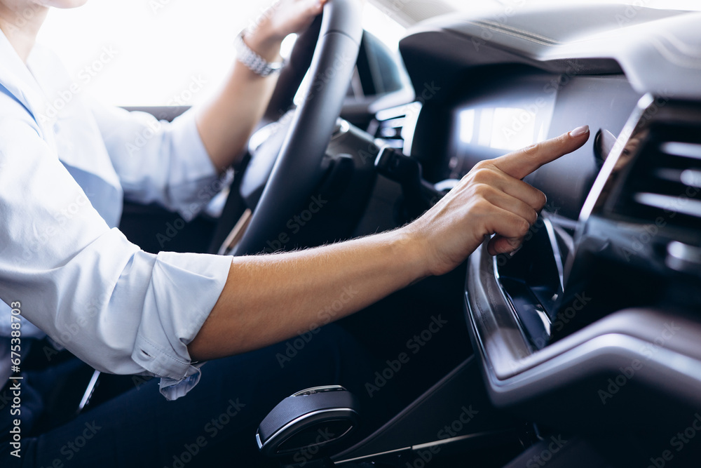 Woman sitting in car and using touch screen Woman sitting in car and using touch screen