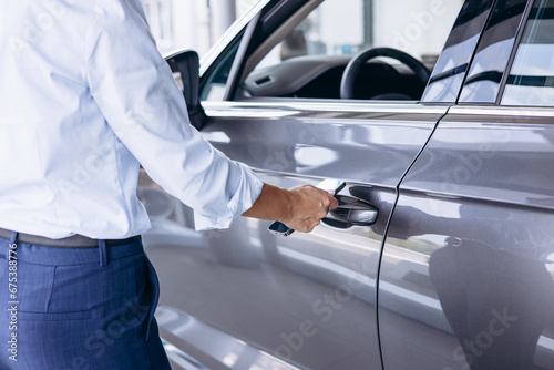 Woman using mobile phone to open her car