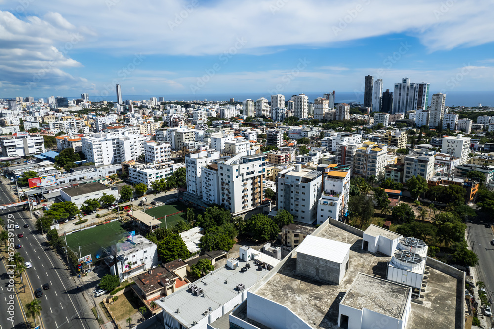 Fototapeta premium Beautiful aerial view of the city of Santo Domingo - Dominican Republic with is Parks, buildings, suburbs ,turquoise Caribbean ocean, parks and malecon