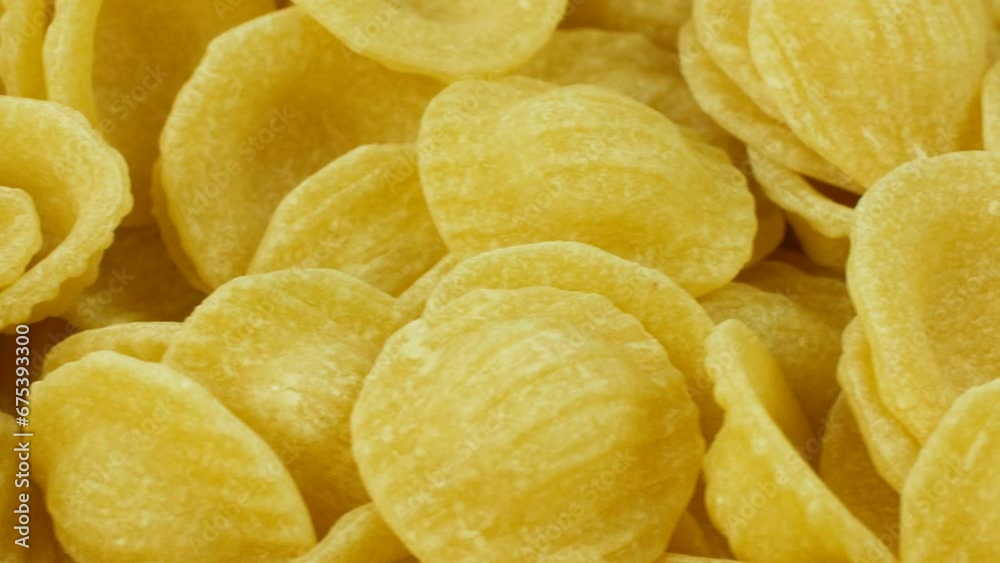 Close video of uncooked Orecchiette pasta in a slow pan. Close video of uncooked Orecchiette pasta in a slow pan.