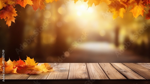 Autumn background, orange maple leaves on wooden table on soft focus light and glowing bokeh background.