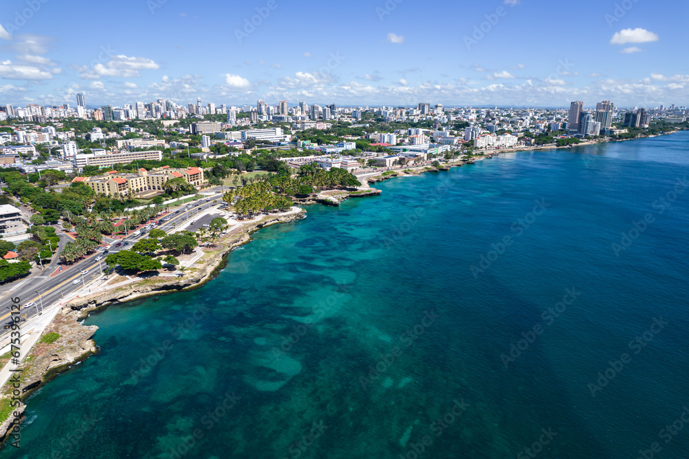 Beautiful aerial view of the city of Santo Domingo - Dominican Republic with is Parks, buildings, suburbs ,turquoise Caribbean ocean, parks and malecon - obrazy, fototapety, plakaty 