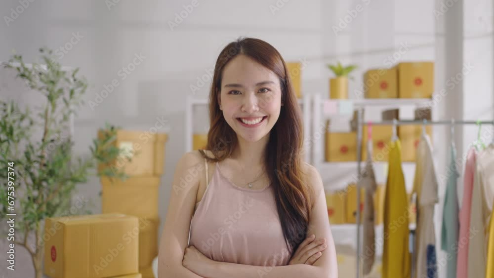 Slow motion Portrait Asian female SME retail store owner in her home office with parcel box background. Fashion designer Startup small business SME concept. Slow motion Portrait Asian female SME retail store owner in her home office with parcel box background. Fashion designer Startup small business SME concept.