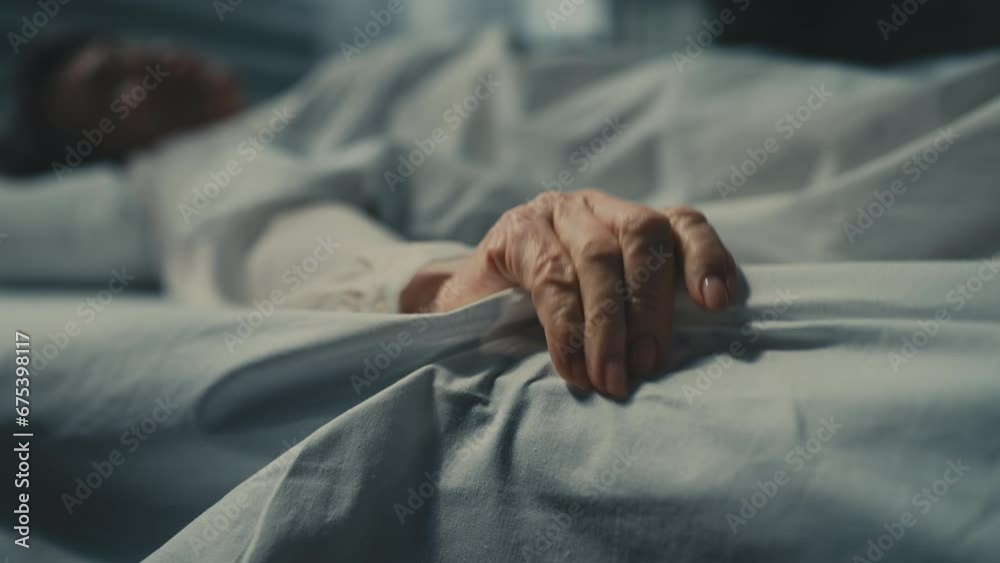 Close-up of terminally ill senior woman lying in bed, suffering from strong pain Close-up of terminally ill senior woman lying in bed, suffering from strong pain