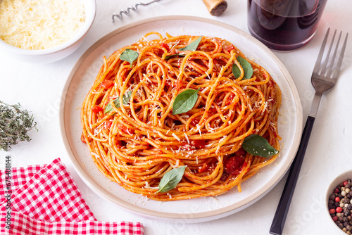 Spaghetti pasta with tomato sauce, basil and Parmesan cheese. Italian cuisine. Vegetarian food.