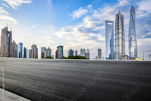 Fototapeta Naklejka Na Ścianę i Meble -  Asphalt road and city buildings skyline background in Shanghai