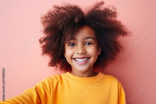 Wallpaper Mural happy african american child girl takes a selfie on a smartphone against the background of a pink room Torontodigital.ca