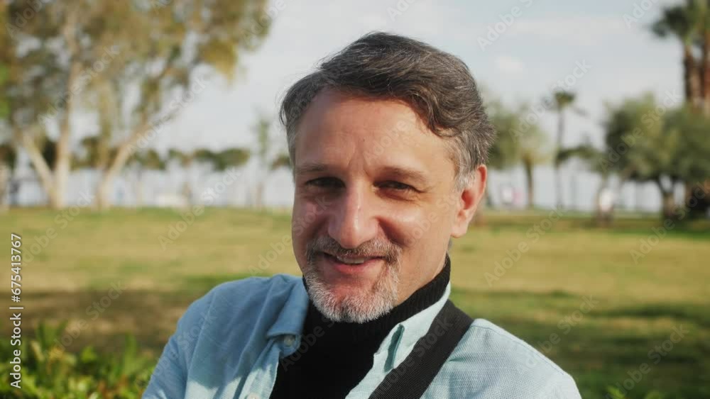 Portrait of a confident happy adult middle aged male looking at camera, posing and charmingly smiling. Successful man outdoor. Portrait of a confident happy adult middle aged male looking at camera, posing and charmingly smiling. Successful man outdoor.