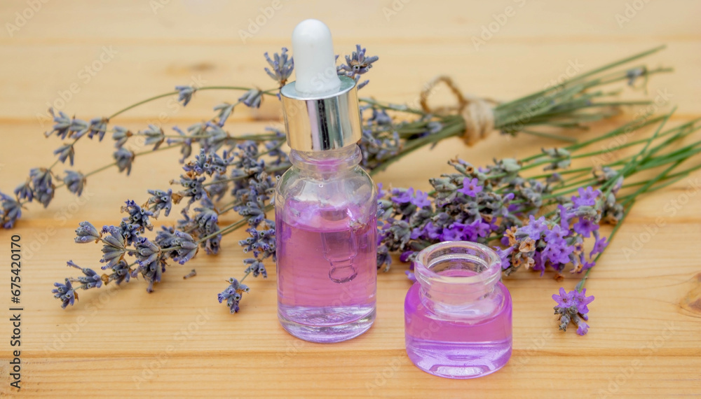 lavender essential oil, on a wooden background. Selective focus. lavender essential oil, on a wooden background. Selective focus.