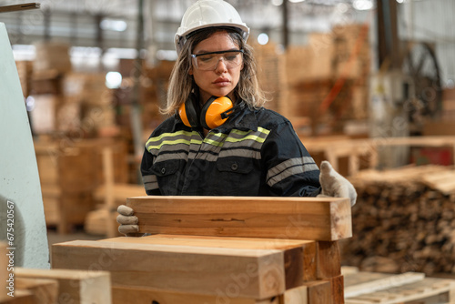 Caucasian business or technician craft woman working with machine and timber at wood factory