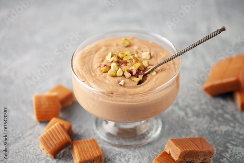 Fotografija Homemade butterscotch pudding in glass cream bowl on the table