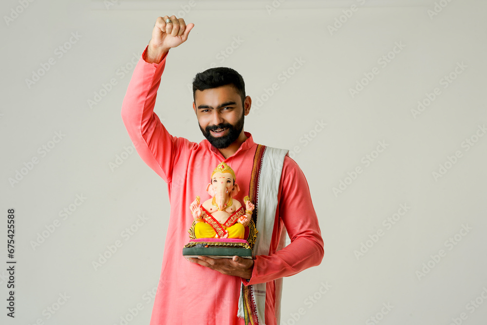 Obraz premium Young Indian man with Lord Ganesha , Celebrating Ganesha festival