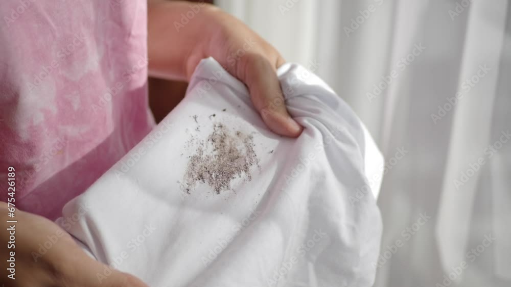women hand holding shirt, showing making stain women hand holding shirt, showing making stain