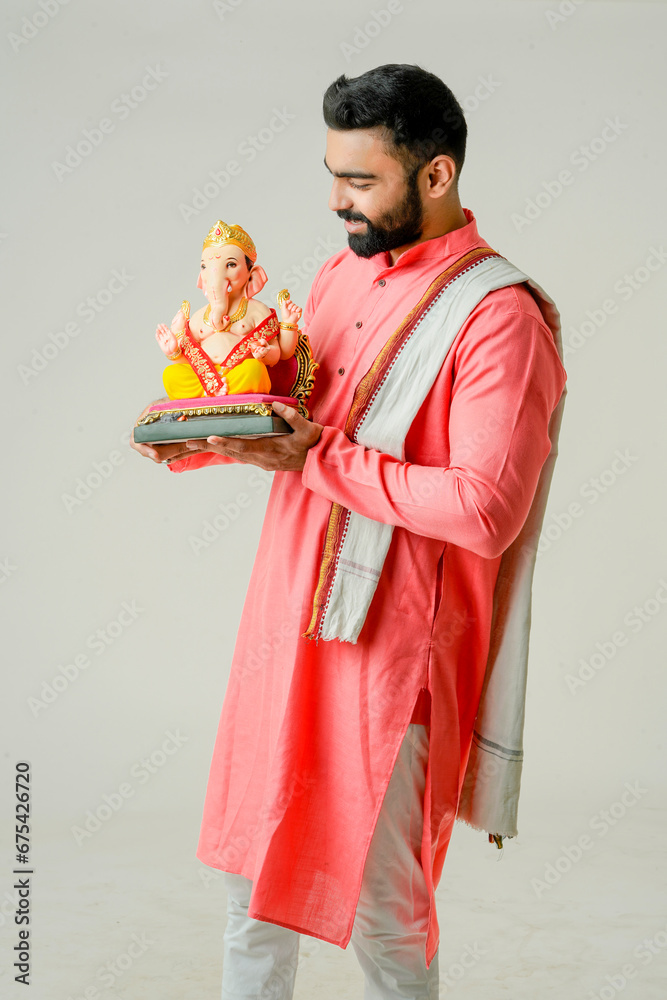 Young Indian man with Lord Ganesha , Celebrating Ganesha festival Young Indian man with Lord Ganesha , Celebrating Ganesha festival