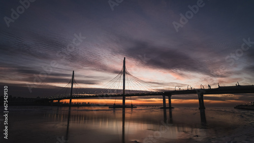 Cable-stayed bridge in the evening at sunset © GMisman