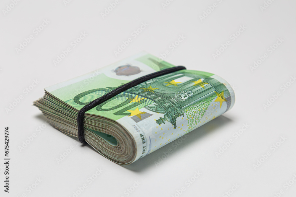 Bundle of 100 euro banknotes isolated on a white background.
Bundle of 100 euro banknotes isolated on a white background.