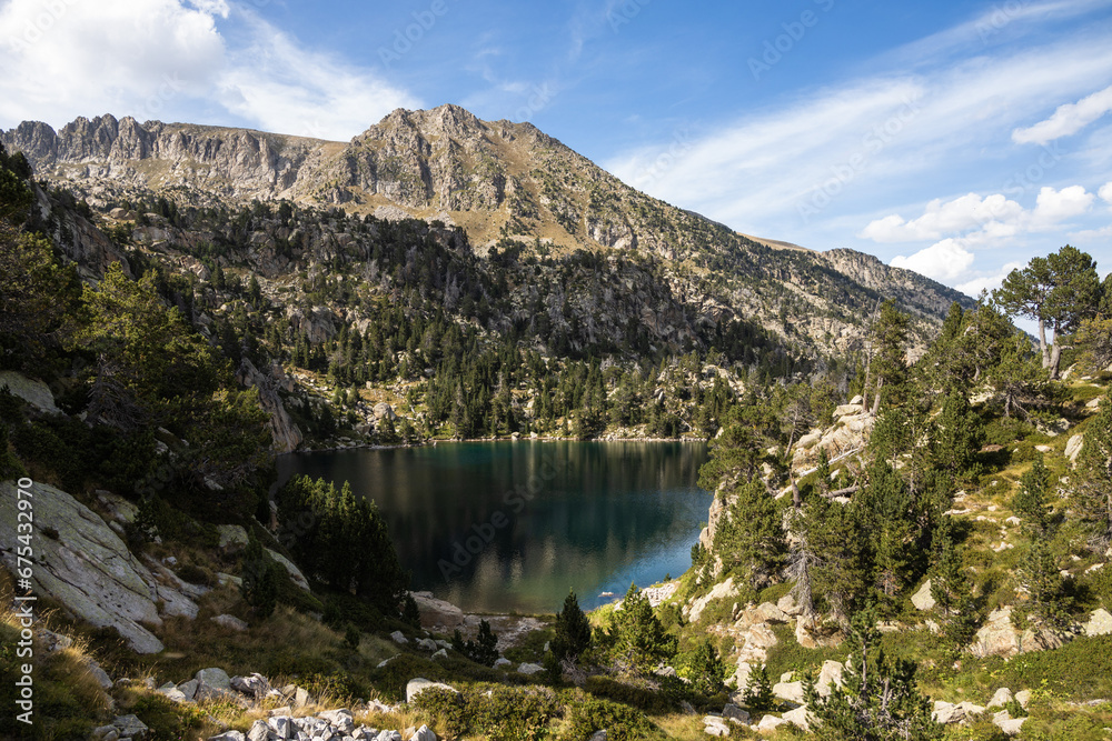 Beautiful landscape of Black lake (Estany negre) in the natural park of Aigestortes y Estany de Sant Maurici, Pyrenees valley with river and lake