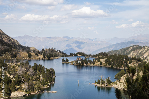 Beautiful landscape of Black lake (Estany negre) in the natural park of Aigestortes y Estany de Sant Maurici, Pyrenees valley with river and lake © olly_plu