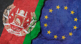 Afghanistan and European Union flags, concrete wall texture with cracks, grunge background, military conflict concept