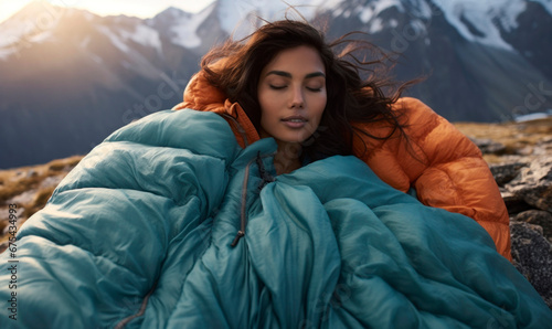 Relaxed woman adventurer waking up camping in mountains photo