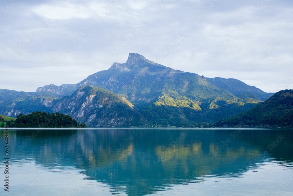 an alpine lake surrounded by mountains and water in the middle of the frame