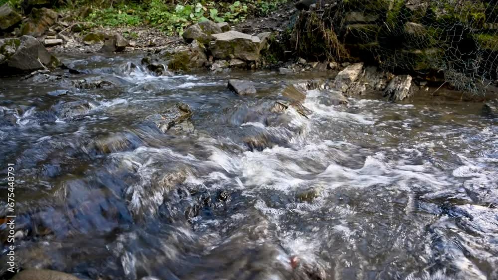 Wild mountain river flowing through stone boulders. Abundant clear stream in carpathians. Wild mountain river flowing through stone boulders. Abundant clear stream in carpathians.