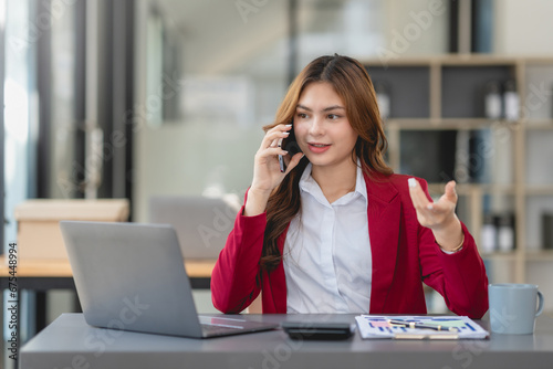 Young businesswoman making a professional phone call in her office...
