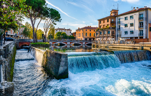 Fototapeta Naklejka Na Ścianę i Meble -  Evening view of the San Martino bridge. Italian city of Treviso in the province of Veneto. View of the river Sile and the architecture of the city of Treviso Italy. 