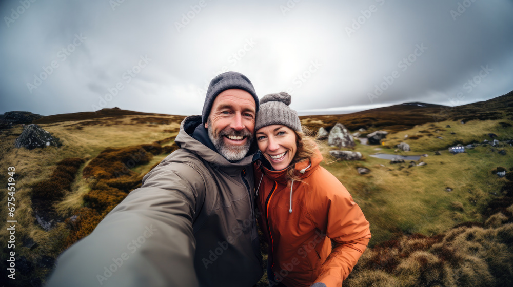 Happy traveling couple making selfie mountains background, sunny summer colors, romantic mood. Happy laughing emotional faces.