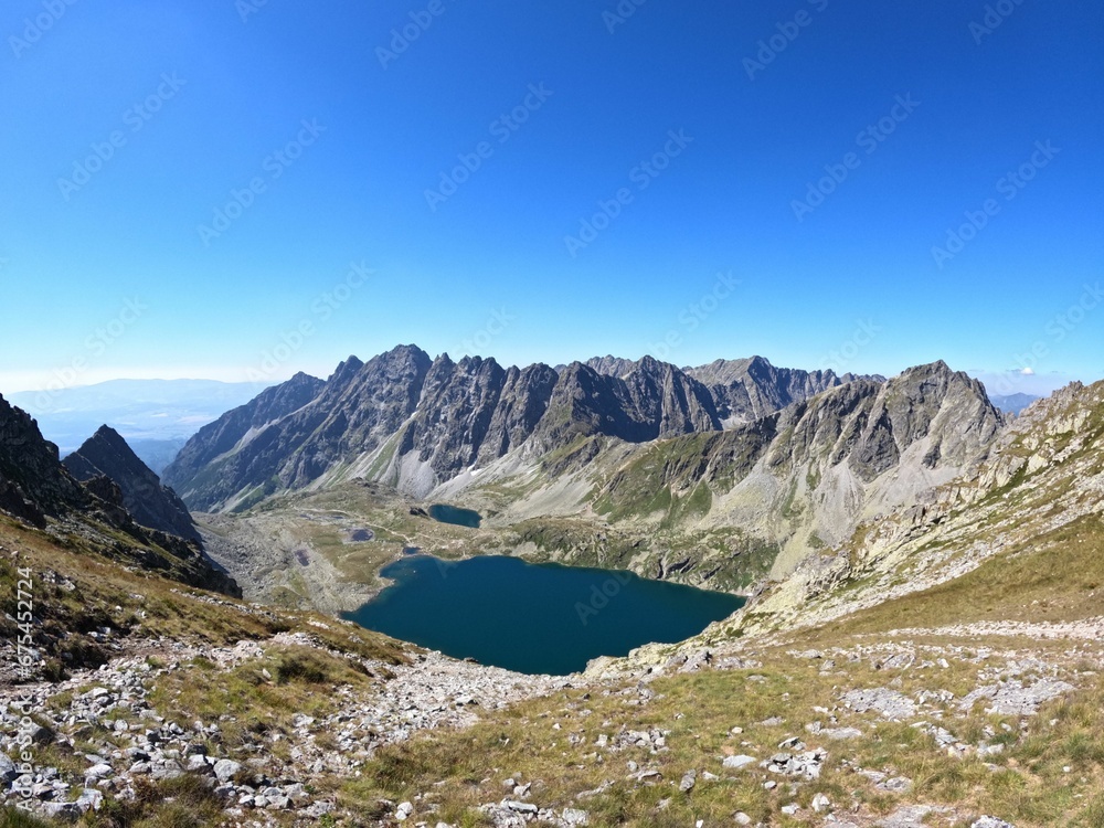 view of lake from the summit of person high in mountains