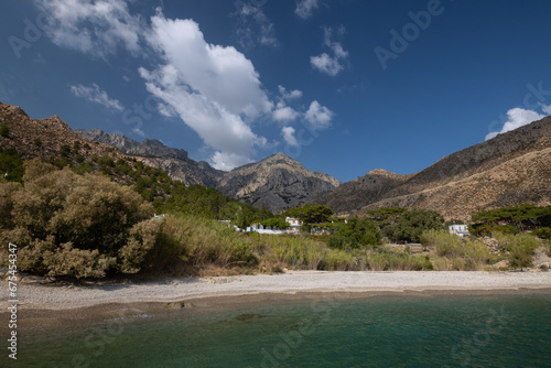 Gorgeous view to the naturalo beauty of Trapalou beach embedded in giant mountain range.