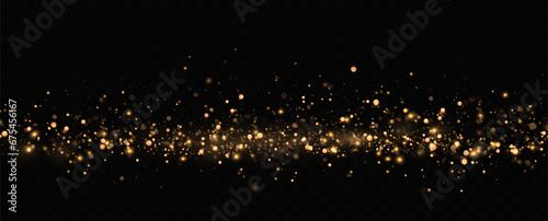 Golden sequins glow with many lights. Glittering dust. Luxurious background of golden particles. 