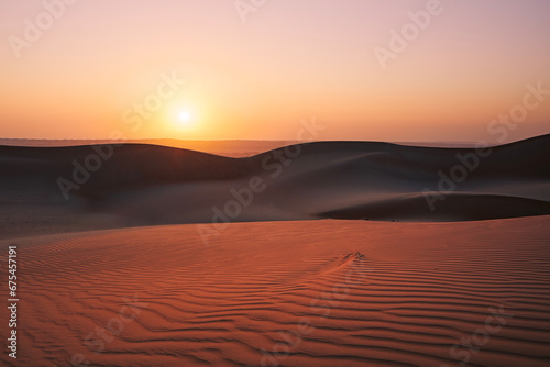 Fototapeta Naklejka Na Ścianę i Meble -  Sand dunes against sky at sunrise. Desert Wahiba Sands in Sultanate of Oman..