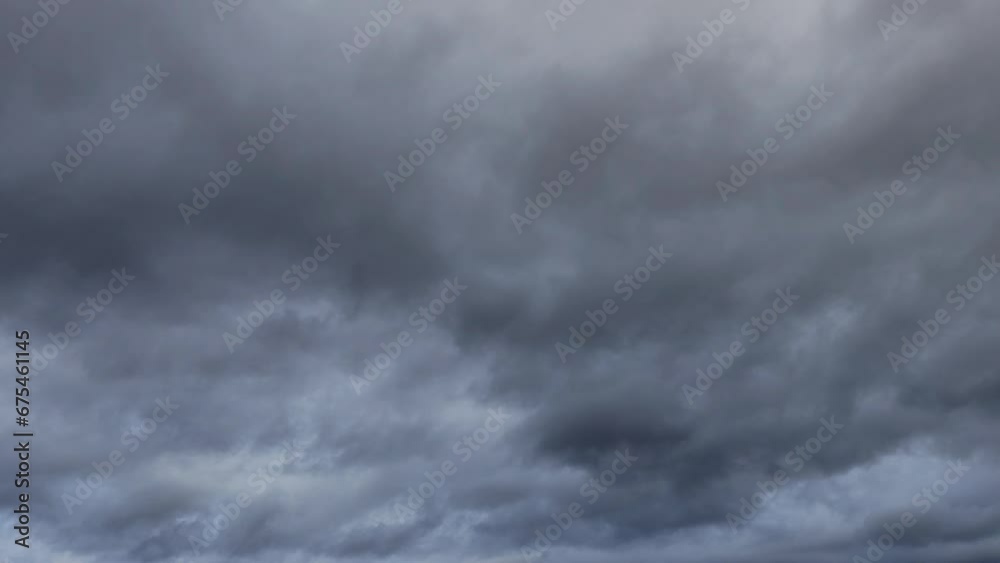 Illuminated sky but with many dark clouds that slide