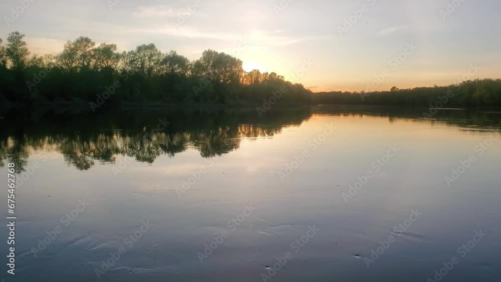 Potamology. Evening dawn over the average course of Don river in spring flood. Smooth flow and whirlpools on the quiet surface of the river. A lot of caddis flies are flying upstream. Russia Potamology. Evening dawn over the average course of Don river in spring flood. Smooth flow and whirlpools on the quiet surface of the river. A lot of caddis flies are flying upstream. Russia