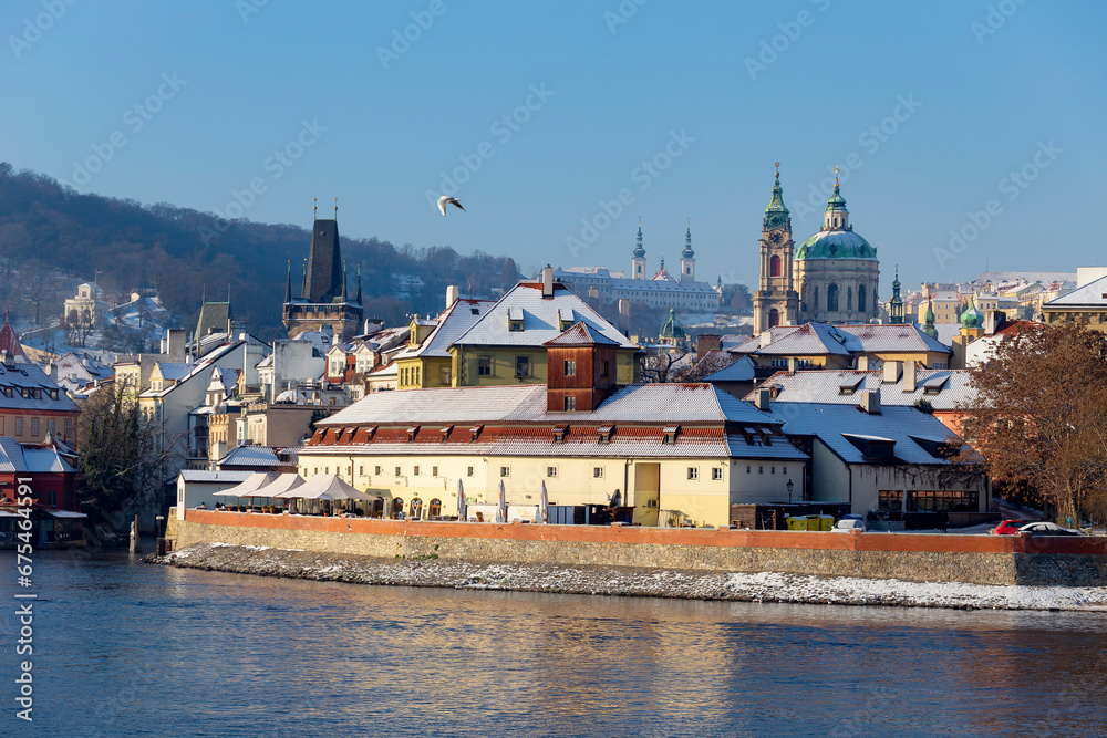 Snowy Prague Lesser Town with Prague Castle above River Vltava in the sunny Day , Czech republic