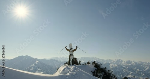 Snowboarder conquering a majestic mountain with a snowboard, extreme off-trail freeriding, winter sports vacations, outdoor winter activities photo