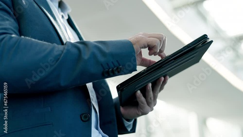 Hands, tablet and closeup with business man, typing and scroll with app, website or chat for networking. Businessman, digital touchscreen and click on web for networking, contact or schedule planning photo