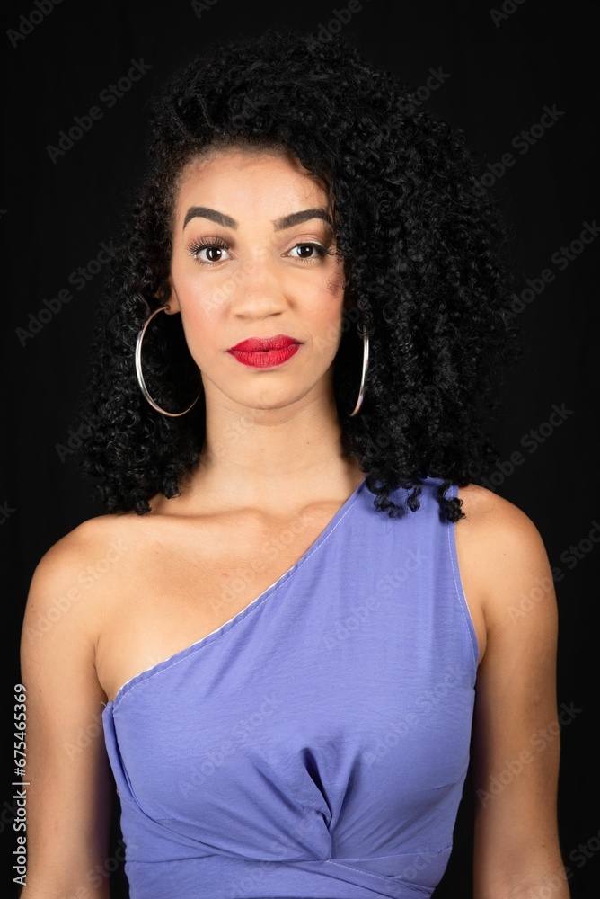 Portrait of serious, beautiful young woman wearing blue outfit. Portrait of serious, beautiful young woman wearing blue outfit.