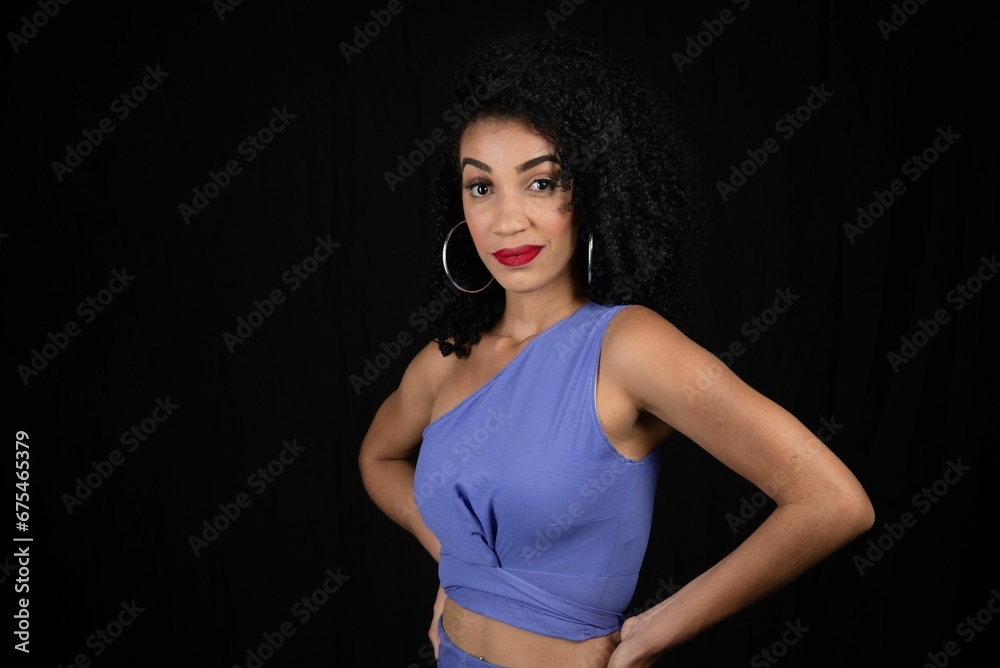 Naklejka premium Portrait of serious, beautiful young woman wearing blue outfit. 