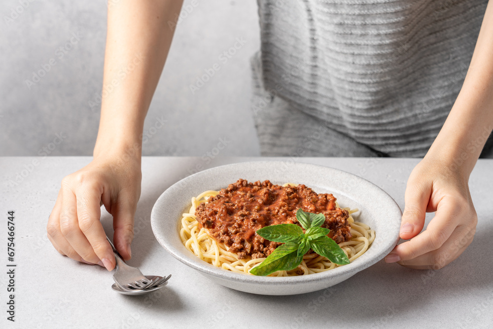 Hand setting tableware. Delicious plate of spaghetti with bolognese sauce Hand setting tableware. Delicious plate of spaghetti with bolognese sauce
